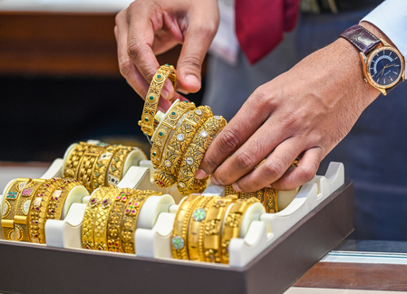 Gold dips marginally, silver drops near 2 pc as US dollar gains